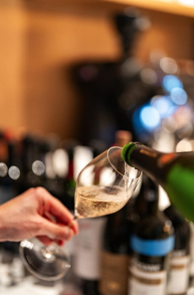 Champagne being poured into a glass at the bar