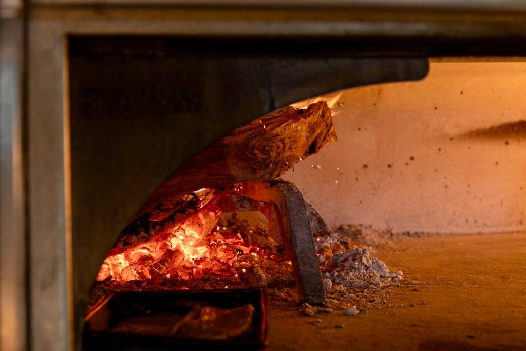 Wood-fired oven with glowing embers